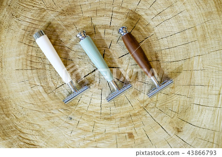 Three traditional steel razors with a brown handle made of valuable wood, bone, natural green stone 43866793