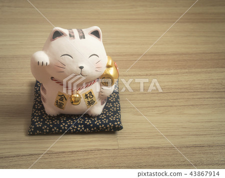 Lucky cat on wood background. Lucky cat on wood background. 43867914