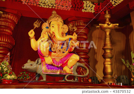 Idol of Lord Ganesha, sitting on his vehicle mouse Idol of Lord Ganesha, sitting on his vehicle mouse 43870532