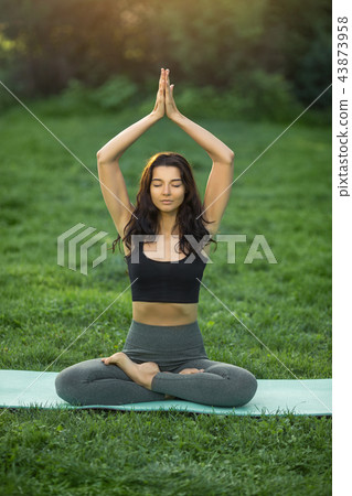 Young girl doing yoga in the park Young girl doing yoga in the park 43873958