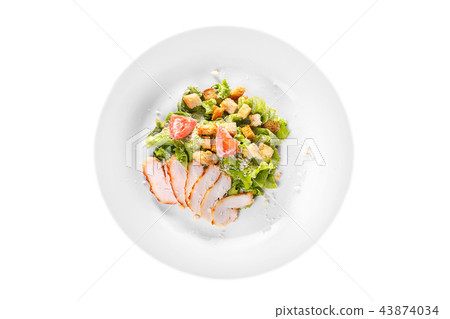 Caesar salad with chicken on plate white isolated Caesar salad with chicken on plate white isolated 43874034