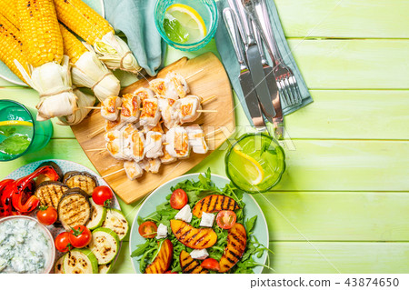 Summer bbq party concept - grilled chicken, vegetables, corn, salad, top view 43874650