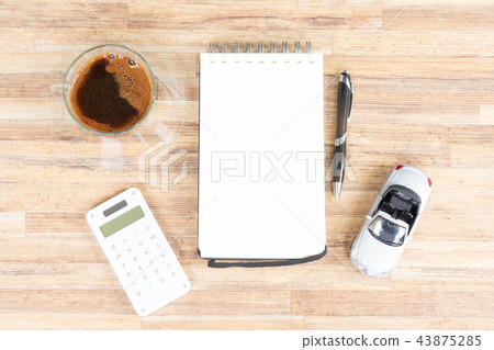 Toy car with notebook, calculator and coffee 43875285