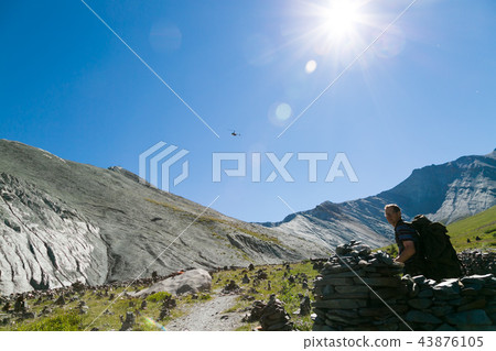 A helicopter in the sky above the mountains. A helicopter in the sky above the mountains. 43876105