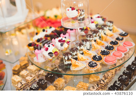 Different kinds of baked sweets on a buffet Different kinds of baked sweets on a buffet 43876110