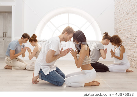 Group of people meditating indoors. Young family therapy 43876858