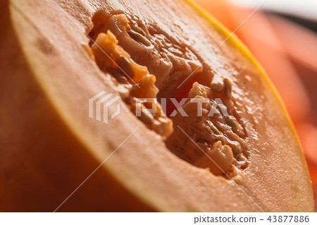 Half of ripe melon close up on blurred background Half of ripe melon close up on blurred background 43877886