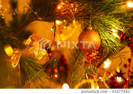 Golden bow and ball on background green Christmas 43877893