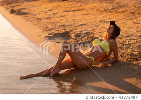 young sexy girl at sunset at the beach young sexy girl at sunset at the beach 43878497