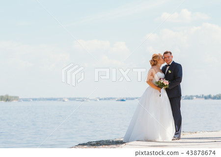 bride and groom on the background of the river bride and groom on the background of the river 43878674