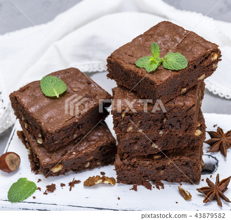 stack of baked square pieces of brownie pie 43879582