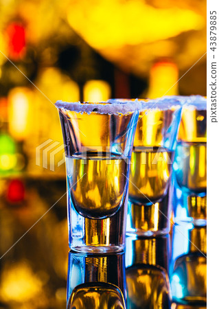 stack of tequila with salt close up on blurred  43879885