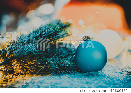 Blue Christmas tree ball next to the branch 43880181