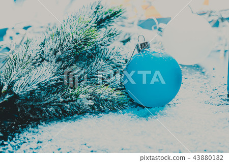 Blue Christmas tree ball next to the branch Blue Christmas tree ball next to the branch 43880182