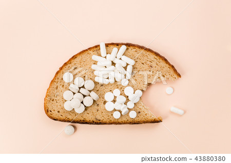 Bitten a piece of bread with a set of vitamins and trace elements. 43880380