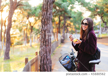 Beautiful young girl on a bicycle posing at the camera Beautiful young girl on a bicycle posing at the camera 43880562