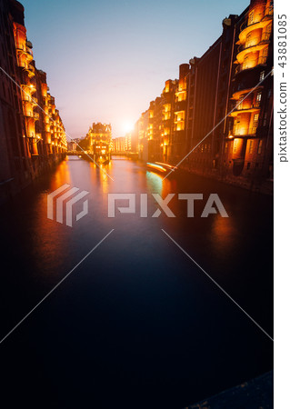 Hamburg, Germany. View of Wandrahmsfleet during sunset with illuminated buildings. Warehouse 43881085