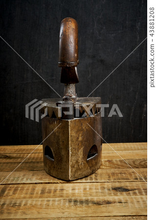vintage old rusty iron on a bright wooden table 43881208
