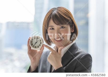 Woman pointing watch Woman pointing watch 43882560