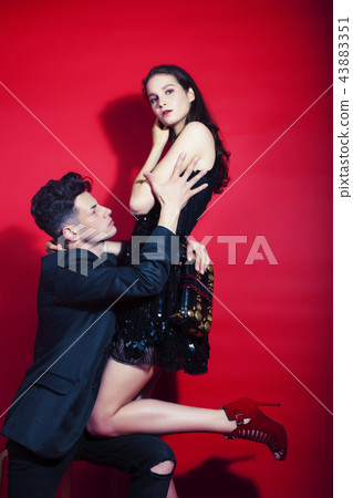 young fashion style couple man and woman on red sexy background, 43883351
