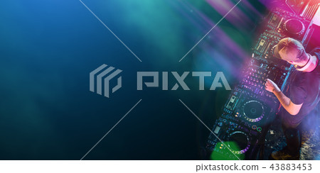 Dj mixes the track in the nightclub at a party Dj mixes the track in the nightclub at a party 43883453