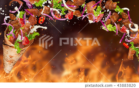 Turkish Kebab yufka with flying ingredients and flames. 43883820