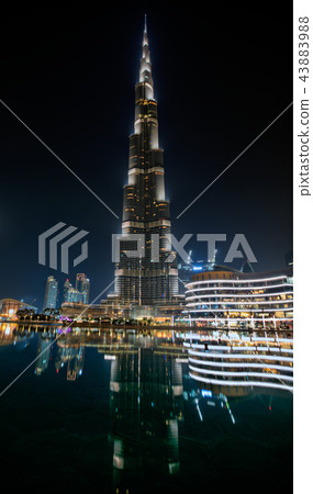 Dubai, United Arab Emirates - May 28 - Night view of Burj Khalifa - the highest building in the world - and lights reflection on the water. 43883988