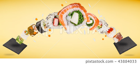 Pieces of delicious japanese sushi frozen in the air. Pieces of delicious japanese sushi frozen in the air. 43884033