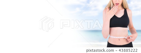 Woman measuring weight with measuring tape on waist on Summer beach with transition 43885222