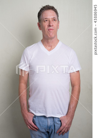 Portrait of mature man with gray hair against white background Portrait of mature man with gray hair against white background 43886945