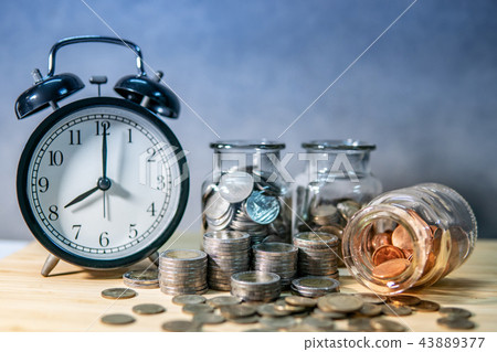 Coin jars and clock. Saving money for retirement 43889377