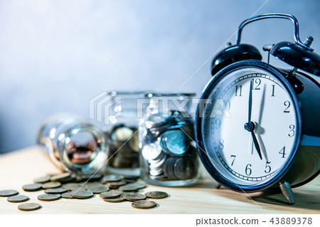 Coin jars and clock. Saving money for retirement Coin jars and clock. Saving money for retirement 43889378