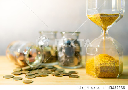 Coin jars and hourglass. Save money for retirement 43889388