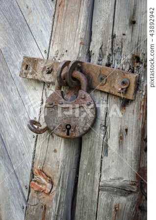 Old lock on the door. lock on the door of an old farmhouse . true village style 43892942