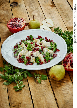 delicious salad of pear gorgonzola cheese and lettuce on a white plate delicious salad of pear gorgonzola cheese and lettuce on a white plate 43893667