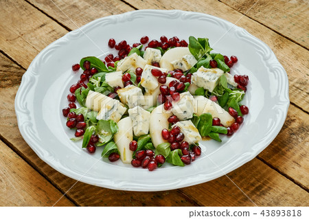 delicious salad of pear gorgonzola cheese and lettuce on a white plate delicious salad of pear gorgonzola cheese and lettuce on a white plate 43893818