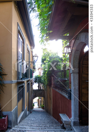 Narrow street with shops on sides 43894383