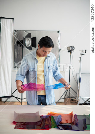 Photographer choosing color filter Photographer choosing color filter 43897340