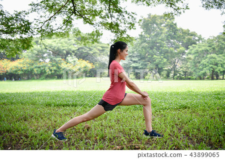 Exercise concept. Beautiful girl is stretching her muscles. Beau Exercise concept. Beautiful girl is stretching her muscles. Beau 43899065