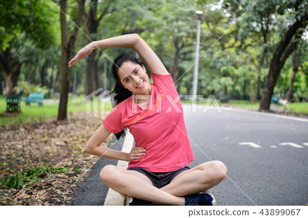 Exercise concept. Beautiful girl is stretching her muscles. Beau Exercise concept. Beautiful girl is stretching her muscles. Beau 43899067