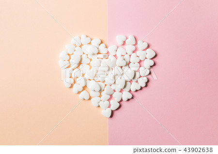 Tablets in the form of hearts on a double pink Tablets in the form of hearts on a double pink 43902638
