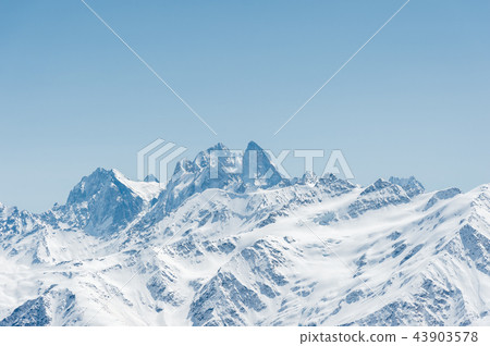 Winter snow covered mountain peaks in Caucasus. Great place for winter sports. Ushba mountain Winter snow covered mountain peaks in Caucasus. Great place for winter sports. Ushba mountain 43903578