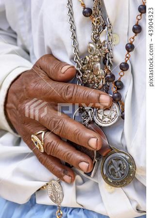 Detail of hands holding religious symbols Detail of hands holding religious symbols 43904323