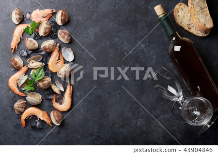 Fresh seafood and white wine on stone table Fresh seafood and white wine on stone table 43904846