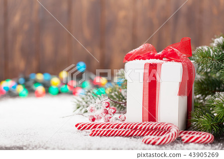 Christmas gift box, candy canes and tree Christmas gift box, candy canes and tree 43905269