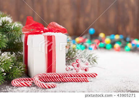 Christmas gift box, candy canes and tree Christmas gift box, candy canes and tree 43905271
