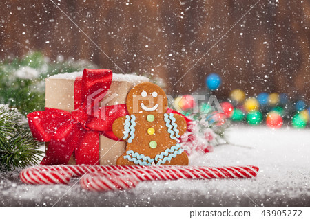 Christmas gift, candy canes and gingerbread man Christmas gift, candy canes and gingerbread man 43905272