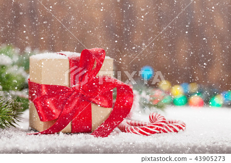 Christmas gift box, candy canes and tree Christmas gift box, candy canes and tree 43905273