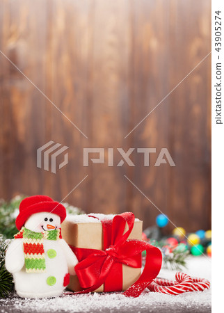 Christmas gift box, candy canes and snowman Christmas gift box, candy canes and snowman 43905274