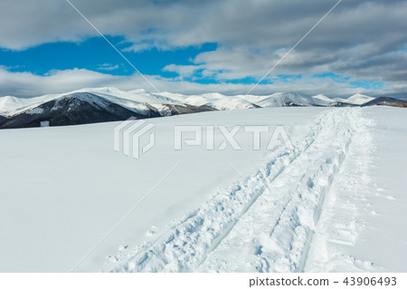 Sledge trace and footprints on winter mountain Sledge trace and footprints on winter mountain 43906493